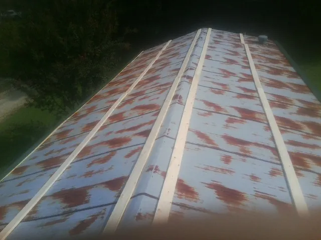 Rusted metal roof panels with new wood purlins before replacement — Storm Damage Roof Repair in Meriden by Roofing Brothers