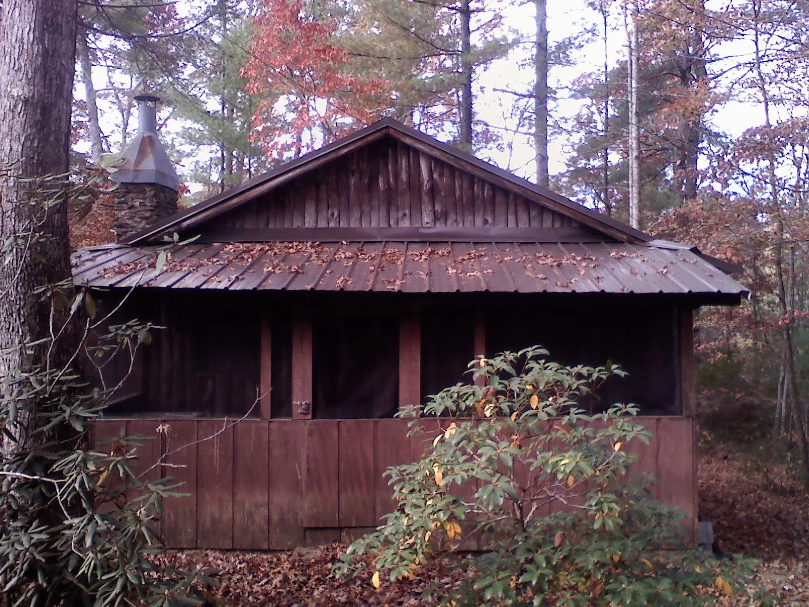 Metal roof over the screened porch of a rustic cabin in Meriden