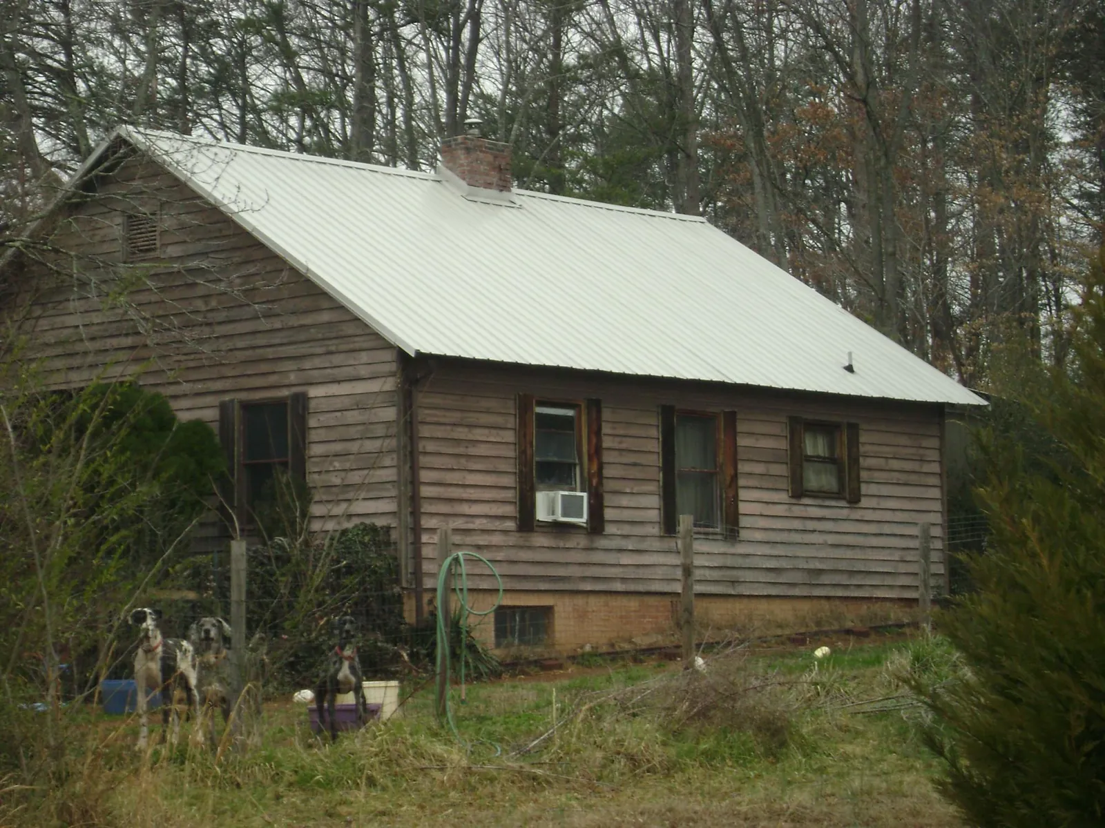 White metal roof on an old wood sided farmhouse, from a Asphalt Shingle Roof Repair job in Meriden